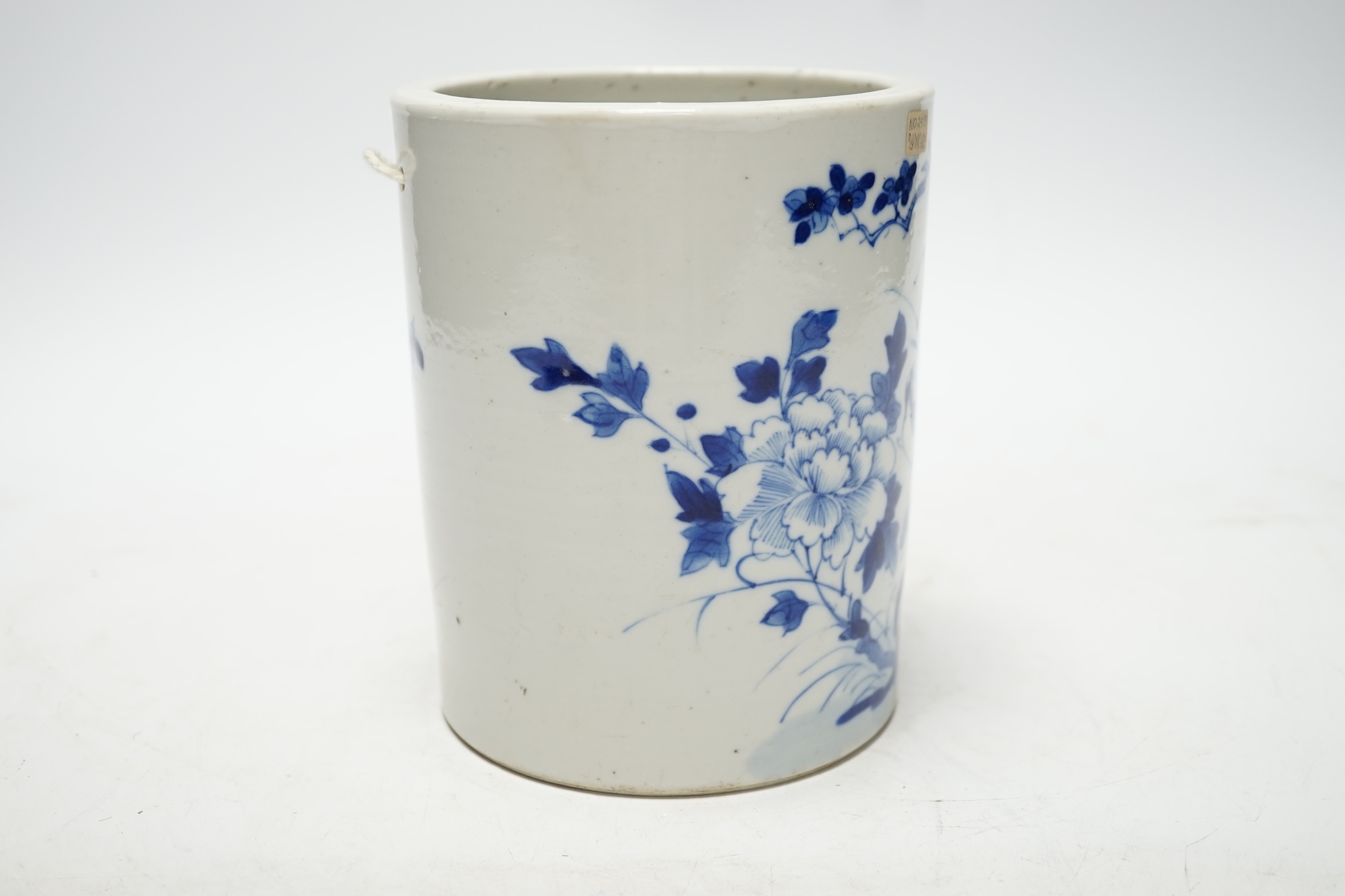 A 19th century Chinese cylindrical blue and white brushpot, later drilled holes, 15cm